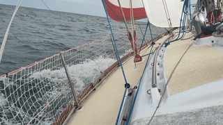 Two sailboats racing upwind